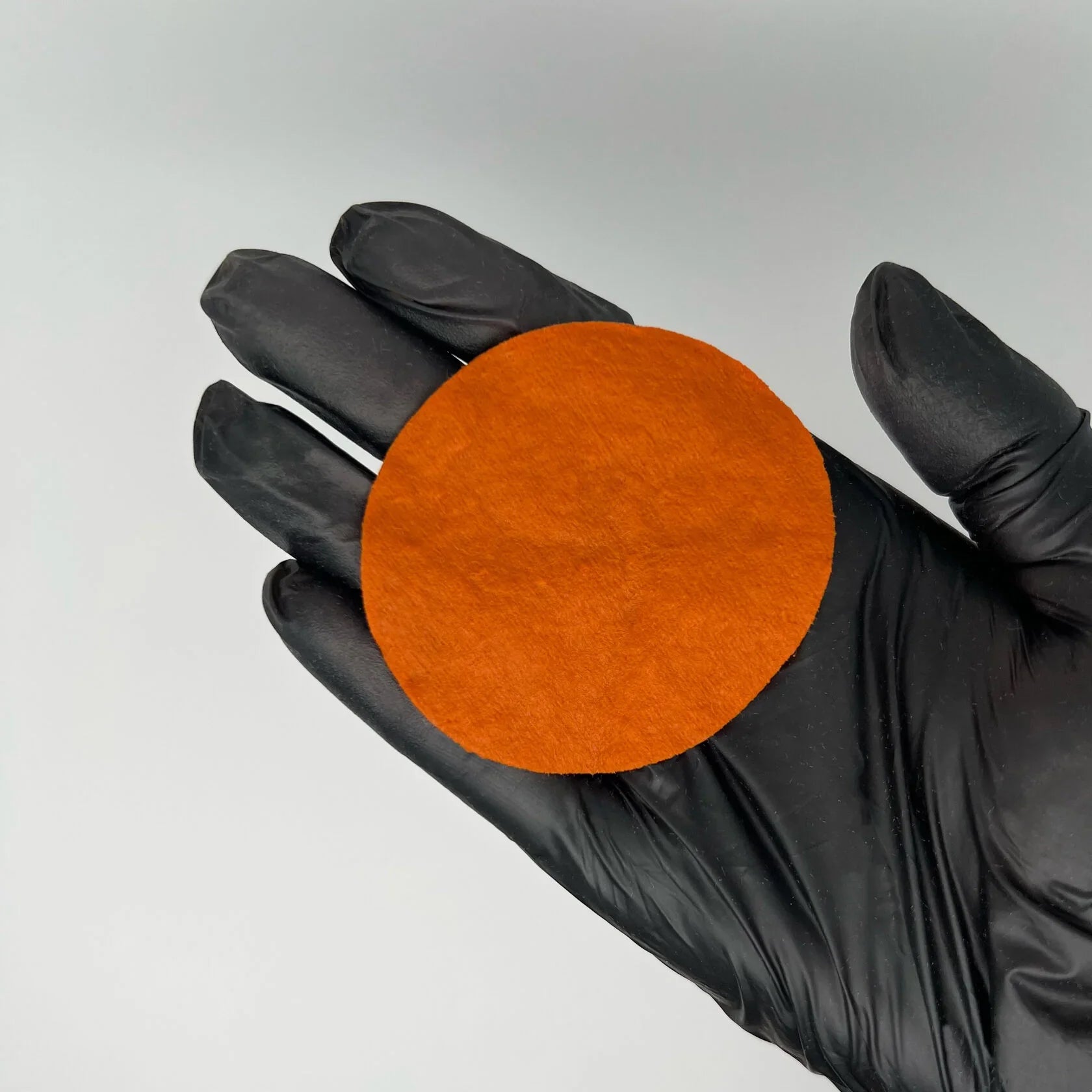 Orange Neutralizer swatch on cotton pad – medium orange